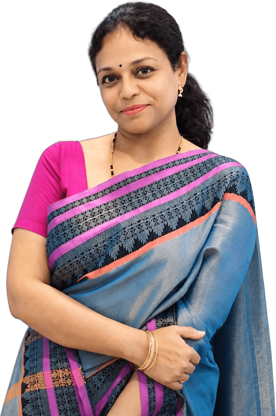 Dr. Roopa B Ankad, holistic life coach, smiling in a blue and pink silk saree
